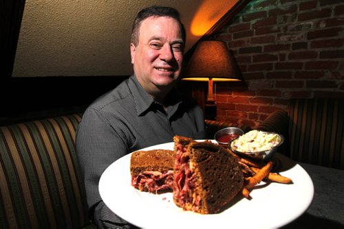 Bailey's owner Leo Groumoutis showing off his reuben, which he has making since the '70s. BORIS MINKEVICH / WINNIPEG FREE PRESS. JAN 31, 2014