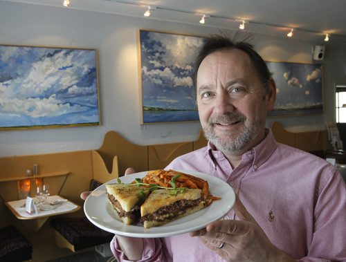 49.8 Intersection piece on Reubens.  Scot McTaggart, owner of the Fusion Grill, 550 Academy Rd. with their New Rueben with crispy Yam fries. For Dave Sanderson story Wayne Glowacki / Winnipeg Free Press Feb.5   2014