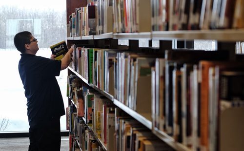 Library clerk, Brian Mercer, restocks the shelves at the recently opened Gaynor Family Regional Library in Selkirk, Manitoba, with a $1.5 m donation from the Gaynor family. 140204 - February 04, 2014 MIKE DEAL / WINNIPEG FREE PRESS