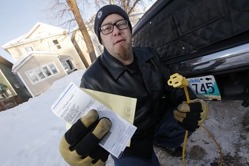 February 4, 2014 - 140204  -  Paul Peters, who was given a parking ticket for plugging his car in on the street, is photographed with his ticket and extention cord in Winnipeg Tuesday, February 4, 2014. John Woods / Winnipeg Free Press