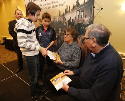 Two students  Left (striped top)  Kyle Courchene 13 and  Joshua Wilson age 9  present tobacco to Elders Bone & Pratt will accept and present OHP,  ¬ as Chief Morris Shanacappo   far left looks on Äì kids receive -  copies of Untuwe Pi Kin He ( Who We Are)  Treaty Elders Teachings Vol. 1 ÄúVolume 1 is a priceless gift for future generations who will now know what was said by whom in the remarkable times of the past 100+ years,Äù said TRCM Commissioner, James Wilson. ÄúIt is also the most substantial piece of written work performed by our collective First NationsÄô community since the creation of the Wahbung document in October of 1971.ÄùIt took nearly a decade to interview over 200 Elders from 62 communities and five different linguistic groups but now that the inaugural volume of the Oral History Project (OHP) is complete, Manitoba is well on its way to preserving some of the most important First NationsÄô teachings of the past century. Treaty Relations Commission of Manitoba (TRCM), the Assembly of Manitoba Chiefs (AMC), and the Council of Elders for the release of Treaty Elders Teachings: Untuwe Pi Kin He (Who We Are), the first of a four volume series. , FEB. 6 2014 / KEN GIGLIOTTI / WINNIPEG FREE PRESS