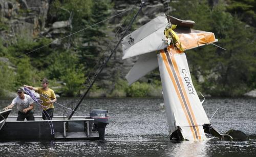 John Woods / Winnipeg Free Press / June 18/07- 070618  - Cliff Dyrkacz (left) and Matt Walker remove the tail section of a small plane from West Hawk Lake Monday June 18/07.  RCMP removed the plane that crashed in West Hawk Lake Monday June 11/07.  Two men died in the crash.