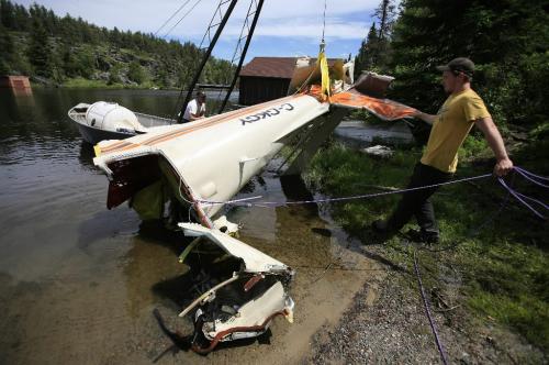 John Woods / Winnipeg Free Press / June 18/07- 070618  - Cliff Dyrkacz (left) and Matt Walker remove the tail section of a small plane from West Hawk Lake Monday June 18/07.  RCMP removed the plane that crashed in West Hawk Lake Monday June 11/07.  Two men died in the crash.