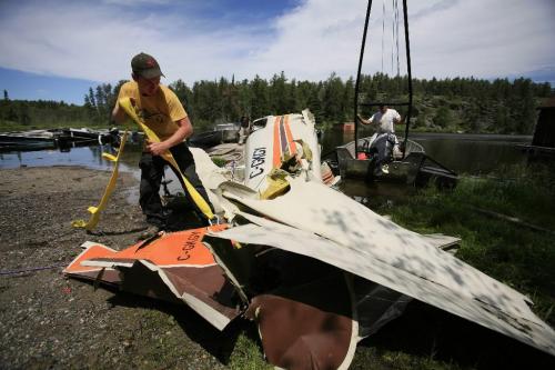 John Woods / Winnipeg Free Press / June 18/07- 070618  - Cliff Dyrkacz (right) and Matt Walker remove the tail section of a small plane from West Hawk Lake Monday June 18/07.  RCMP removed the plane that crashed in West Hawk Lake Monday June 11/07.  Two men died in the crash.