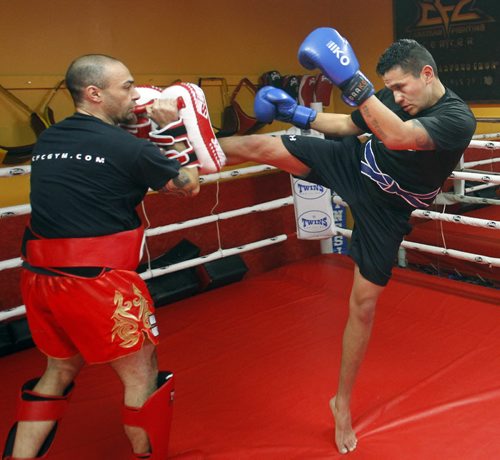 49.8  TRAINING BASKET.   Wab Kinew, broadcaster, artist, and U of W's Director of Indigenous Inclusion trains in mixed martial arts at the Canadian Fighting Centre. In photo, Kinew at right practicing Kick Boxing with Giuseppe DeNatale the CFC president/owner.  Ashley Prest story. Wayne Glowacki / Winnipeg Free Press Feb.7   2014