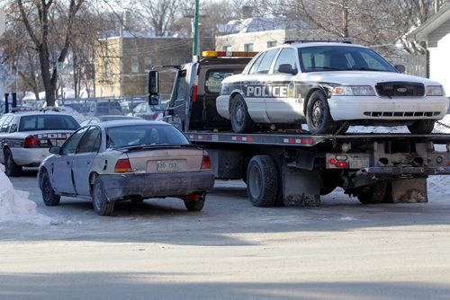 Police car and another small car possibly involved in a chase that ended at St. Mary and Good.  BORIS MINKEVICH / WINNIPEG FREE PRESS. FEB 7, 2014