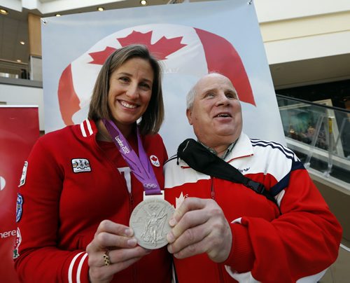 Stdup - Wpg Olympians (left)  Janine Hanson  winner of a silver medal  in women's eight's  rowing 2012  Summer Games in London  showing her medal  at a Polo Park opening of the Red Leaf Lounge at Centre Court , a big screen tv  and stage will be  on hand for customers to watch the Olympics in Sochi Russia  while shopping- (right) 1988 Para Olympian Shep Shell , blind marathon runner was also  on hand to meet the public on this, the opening of the 2014 Olympics , FEB. 7 2014 / KEN GIGLIOTTI / WINNIPEG FREE PRESSFEB. 7 2014 / KEN GIGLIOTTI / WINNIPEG FREE PRESS