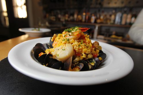 RESTAURANT REVIEW - Fusion Grill - Paella with spicy house made sausage, prawns, chicken, scallops, mussels, artichoke, red pepper, broad beans, Arborio rice and saffron. BORIS MINKEVICH / WINNIPEG FREE PRESS. FEB 7, 2014