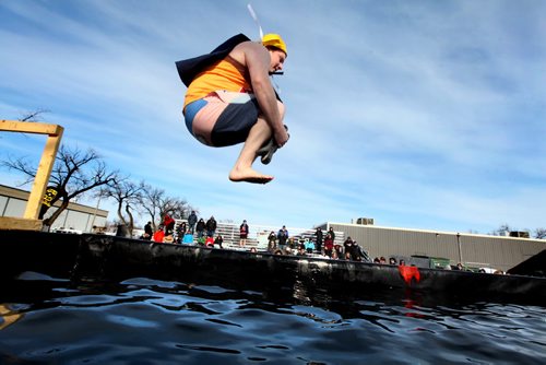 Darren Anderson does a cannonball jump into a BFI bin filled with icy, cold water at the Friendship Centre Saturday afternoon as part of the Polar Plunge, a fundraiser to raiser money for the special Olympics.   Feb 08,, 2014 Ruth Bonneville / Winnipeg Free Press