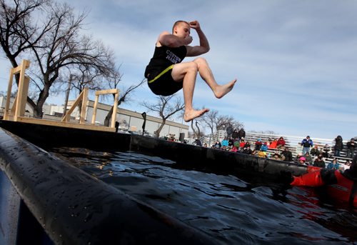 A contestant does a cannonball jump  into a BFI bin filled with icy, cold water at the Friendship Centre Saturday afternoon as part of the Polar Plunge, a fundraiser to raiser money for the special Olympics.   Feb 08,, 2014 Ruth Bonneville / Winnipeg Free Press