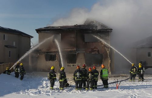 As the smoke clears the destruction  of this afternoons fire on Ed Golding Bay in Transcona becomes apparent - The home is a total loss with officials pegging damage at $400,000-    See story- Feb 10, 2014   (JOE BRYKSA / WINNIPEG FREE PRESS)