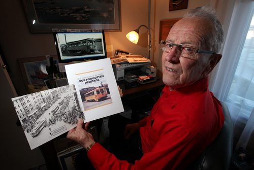 Portrait of former Winnipeg street car operator and retired transit driver Brian Darragh who is self-publishing a history of the citys street cars. He's posing in his home office with the mock up of the book's cover and a photo of the last four Winnipeg Street Cars at Portage and Main making their last run. February 10, 2014 - (Phil Hossack / Winnipeg Free Press)