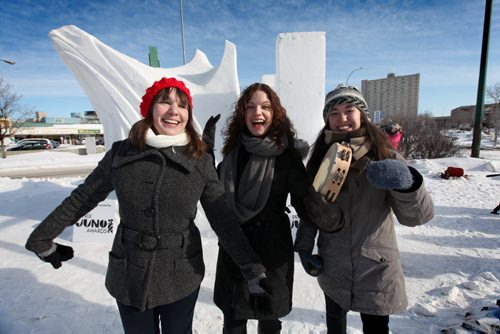 Random Acts of JUNO Manitoba artists like  singer/songwriters Jocelyn Gould (red hat, left) Shannon Kristjanson (centre) and Rayannah Kroeker with the trio band Collage-¾-trois, spread the spirit of music to warm Winnipeger's in non-traditional locations throughout the city like on the Festival du Voyageur snow sculpture on the  corner of St. Mary's and Marion Street Wednesday doing Random Act of JUNO  event,  during the weeks leading up to the JUNO Awards. Feb 12,, 2014 Ruth Bonneville / Winnipeg Free Press