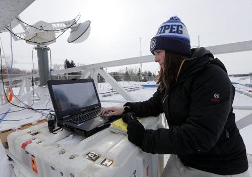 masters student  Megan Shields  operate microwave scatterometer (on boom top left) Green Page - ARCTIC EXPERIMENT -  University of ManitobaÄôs unique Sea-Ice Environmental Research Facility (SERF), thanks to the remarkably cold winter this year, media are invited to watch an Arctic experiment be conducted within city limits (map).Graduate student Megan Shields, supervised by Canada Research Chair David Barber, will create an artificial ridge of ice and then scan it with radar and laser systems from above.The project is trying to understand the signals that radar satellites read off of an ice ridge in the Arctic by duplicating it here on a smaller scale. Years ago, Professor Barber released a study that showed Arctic sea ice had duped satellites into reporting thick multiyear sea ice where in fact none existed, raising doubts about the accuracy of satellite data.Sea-Ice Environmental Research Facility (SERF), University of Manitoba , alex paul story FEB. 12 2014 / KEN GIGLIOTTI / WINNIPEG FREE PRESS