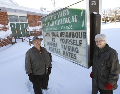 Faith. Minister Ken DeLisle and Dianne Cooper, Chair of the Leadership Team outside their Fort Garry United Church at 800 Point Rd with sign's message. Churches, Mosques, and Temples are putting a common message on their exterior signs: Love Your Neighbour as Yourself: Raise welfare rates. Brenda Suderman story. Wayne Glowacki / Winnipeg Free Press Feb. 14   2014