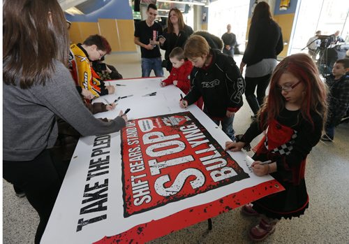 Stdup , Monster Jam and Kids Help Phone team up Stop Bullying  Champaign  in Wpg at the MTS Centre monster truck driver Cam McQueen  and Wpg activist Michael Redhead Champagne  founder of Aboriginal Youth Opportunities  gave a talk  and roll playing  demonstration on how to deal with cyber bullying for local youth . The kids also signed a pledge board against bullying .Monster Jam on Feb 15-16 at MTS Centre ,   FEB. 14 2014 / KEN GIGLIOTTI / WINNIPEG FREE PRESS