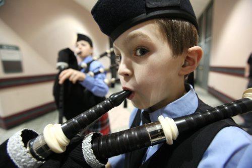 Eleven year old Gavin Zimmer practices his technique while waiting to perform playing his bagpipe in front of a judge at the Western Canada's largest indoor piping and drumming competition Saturday morning at the Convention Centre.  The free event runs all day (until 5pm).  Boy in the background is 12 year old Ezra Felstrom-Stenka.  Standup photo.  Feb 15,, 2014 Ruth Bonneville / Winnipeg Free Press
