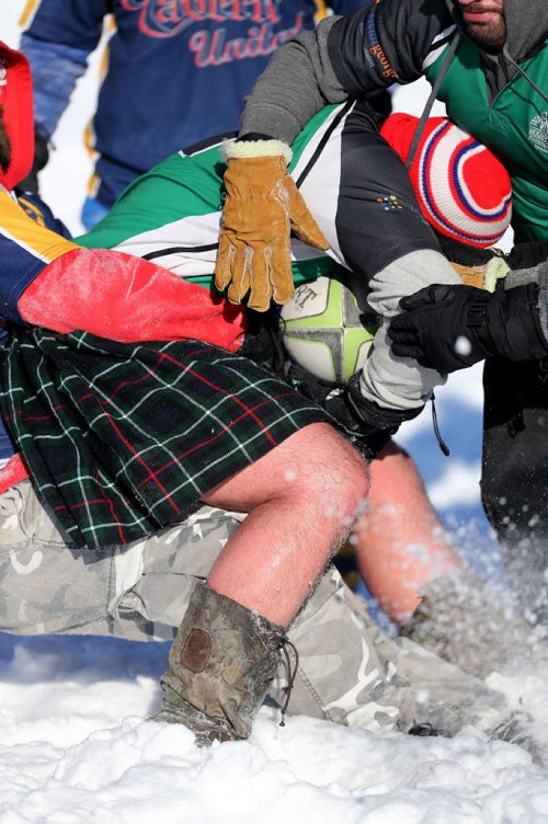 Daniel Dickson, wearing a kilt, of the Winnipeg Wanderers carries the ball during a game against the Winnipeg Saracens during the Winnipeg Wasps Snow 7's Annual Rugby Tournament on the intersection of the Red and Assiniboine Rivers, Saturday, February 15, 2014. (TREVOR HAGAN/WINNIPEG FREE PRESS)