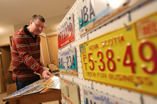 Manny Jacob, a member of the ALPCA, an international association of license plate collectors, and part of his collection, Friday, February 14, 2014. (TREVOR HAGAN/WINNIPEG FREE PRESS) - for 49.8 intersection dave sanderson piece.
