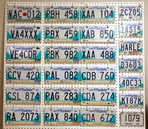 Board contains plates from 1997-present, non passenger plates, such as commercial, public service vehicle and livery. Manny Jacob, a member of the ALPCA, an international association of license plate collectors, and part of his collection, Friday, February 14, 2014. (TREVOR HAGAN/WINNIPEG FREE PRESS) - for 49.8 intersection dave sanderson piece.