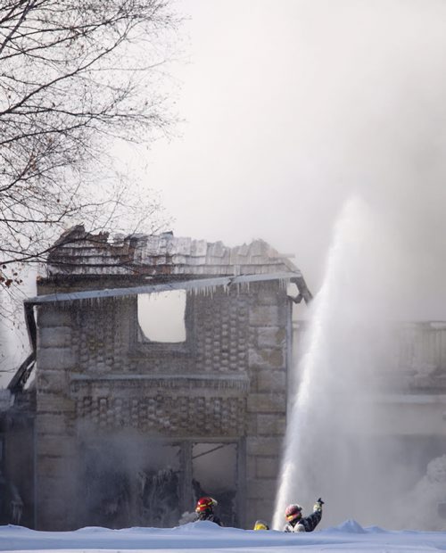 Firefighters still at the scene of a fire in a multi million dollar mansion on the 1000 block of Wellington Crescent, Sunday, February 16, 2014. (TREVOR HAGAN/WINNIPEG FREE PRESS)