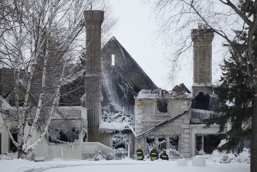February 16, 2014 - 140216  -  Firefighters work on extinguishing hotspots in a fire at 1021 Wellington Crescent in Winnipeg Sunday, February 16, 2014. John Woods / Winnipeg Free Press