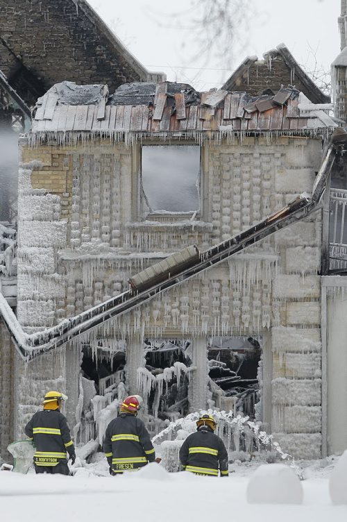 February 16, 2014 - 140216  -  Firefighters work on extinguishing hotspots in a fire at 1021 Wellington Crescent in Winnipeg Sunday, February 16, 2014. John Woods / Winnipeg Free Press