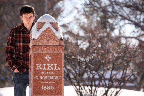 Ben Linnick quietly reflects at Louis Riel's grave site at St. Boniface Cathedral on Louis Riel day. Linnick said as a young Metis growing up in Flin Flon Riel was a role model, and even more so now that he lives in Winnipeg. 140217 - Monday, {month name} 17, 2014 - (Melissa Tait / Winnipeg Free Press)