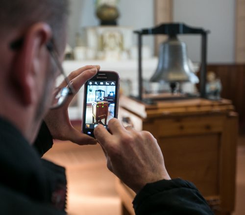 A visitor to the St. Boniface Museum on Louis Riel Day snaps a photo of the Bell of Batoche on display inside the museum. The bell had been taken from Metis community of Batoche, SK by Ontario soldiers in 1885, and later disappeared from a Legion Hall before returning to Saskatchewan last year.  140217 - Monday, {month name} 17, 2014 - (Melissa Tait / Winnipeg Free Press)
