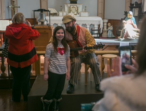 Alexis Wall has her photo taken with performer Stef Paquette at the St. Boniface Museum on Louis Riel Day. The Bell of Batoche is on display in the background. The bell had been taken from Metis community of Batoche, SK by Ontario soldiers in 1885, and later disappeared from a Legion Hall before returning to Saskatchewan last year.  140217 - Monday, {month name} 17, 2014 - (Melissa Tait / Winnipeg Free Press)