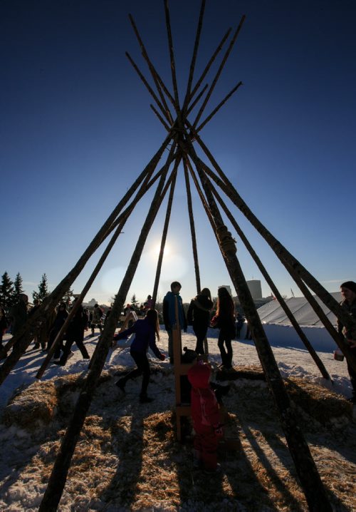 Teens in a teepee in the snow park at Festival Du Voyageur on Louis Riel Day. 140217 - Monday, {month name} 17, 2014 - (Melissa Tait / Winnipeg Free Press)