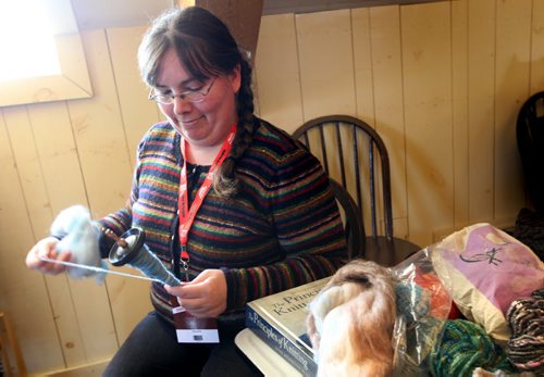 Corie Johnson does some shows how to hand spin wool as an interpreter at one of the textile workshops at the Festival du Voyageur.  See Connie's feature for 49.8  on woven textiles at the Festival.  Feb 15,, 2014 Ruth Bonneville / Winnipeg Free Press
