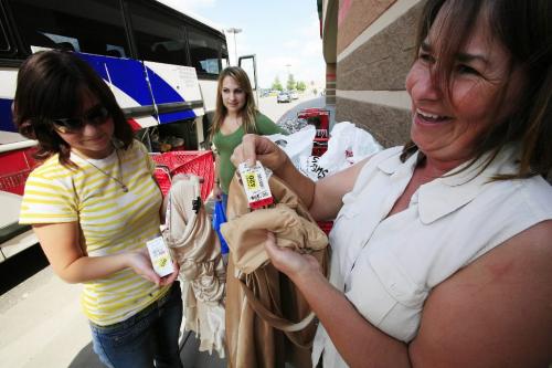 John Woods / Winnipeg Free Press / June 16/07- 070616  - Margaret Post (R) and her daughter Melissa (L) show off their grad dress bargains as friend Stefanie Stobbe looks on outsideTarget in Grand Forks June 16/07.  The high Canadian dollar seems to be encouraging shoppers to head south for some bargains.