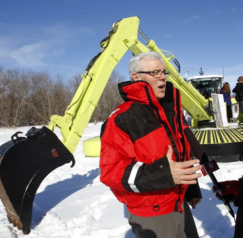 Premier Greg Selinger beside of one of the three Amphibex ice breaking machines out on the Red River north of Selkirk by Netley Creek Tuesday morning part of the 2014 ice jam mitigation program.  Bruce Owen story. Wayne Glowacki / Winnipeg Free Press Feb. 18   2014