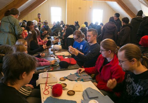 Attendees work with yarn during a Metis textiles workshop at Festival Du Voyageur on Louis Riel Day.  (story for 49.8 by Connie) 140217 - Monday, {month name} 17, 2014 - (Melissa Tait / Winnipeg Free Press)