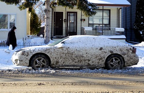A car is splattered with road slop on Mountain Ave.  Mild weather has broken the grip of Winnipeg's winter today. BORIS MINKEVICH / WINNIPEG FREE PRESS  Feb. 18, 2014