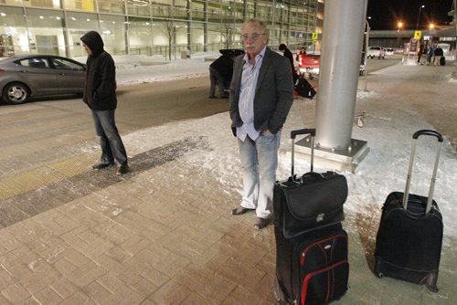 February 19, 2014 - 140219  -  Winnipeg Mayor Sam Katz (L) and former city CAO Phil Sheegl wait for their pickup after arriving together from Phoenix, Arizona at the Winnipeg airport early Wednesday morning, February 19, 2014. John Woods / Winnipeg Free Press