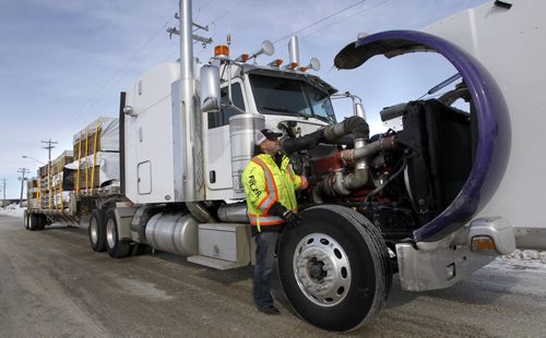Trucker Kelly Ring checks his rig in Winnipeg Wednesday before hauling building supplies to the Garden Hill First Nation. For Alex Paul story on Winter Roads.  Wayne Glowacki / Winnipeg Free Press Feb. 19   2014