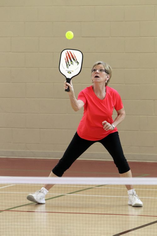 Nina Constable plays Pickleball, a sport that is a little bit badminton, a little bit tennis, at the Sturgeon Heights Community Centre Wednesday morning. 140219 - Wednesday, February 19, 2014 -  (MIKE DEAL / WINNIPEG FREE PRESS)