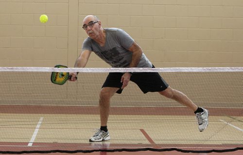 Louis Allec plays Pickleball, a sport that is a little bit badminton, a little bit tennis, at the Sturgeon Heights Community Centre Wednesday morning. 140219 - Wednesday, February 19, 2014 -  (MIKE DEAL / WINNIPEG FREE PRESS)