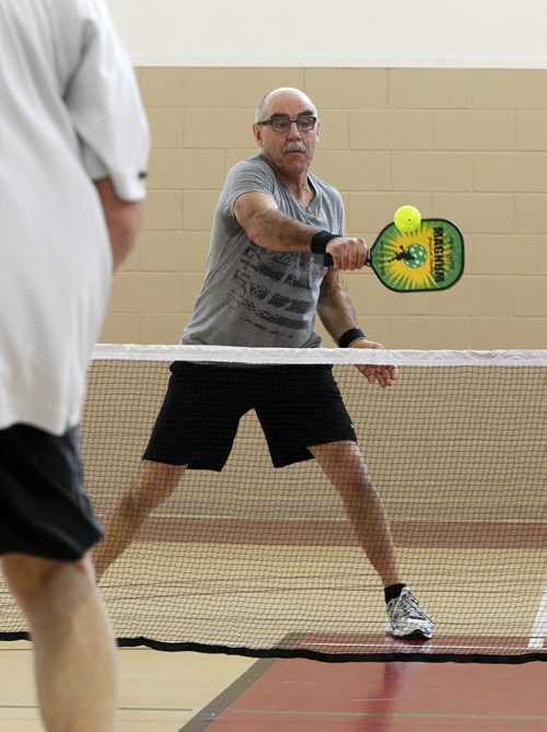 Louis Allec plays Pickleball, a sport that is a little bit badminton, a little bit tennis, at the Sturgeon Heights Community Centre Wednesday morning. 140219 - Wednesday, February 19, 2014 -  (MIKE DEAL / WINNIPEG FREE PRESS)