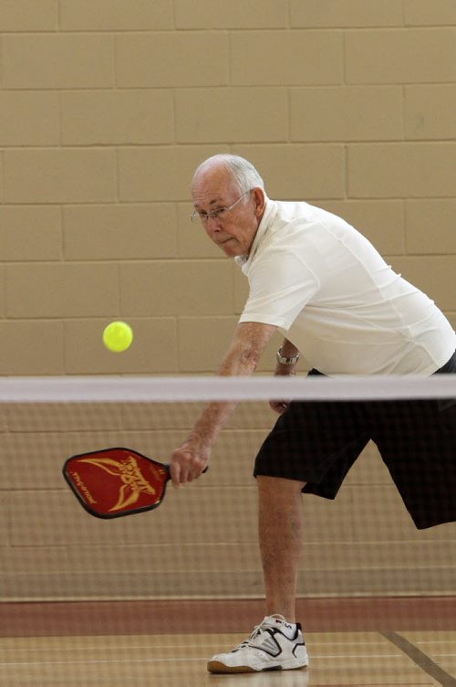 Larry Ladyman plays Pickleball, a sport that is a little bit badminton, a little bit tennis, at the Sturgeon Heights Community Centre Wednesday morning. 140219 - Wednesday, February 19, 2014 -  (MIKE DEAL / WINNIPEG FREE PRESS)