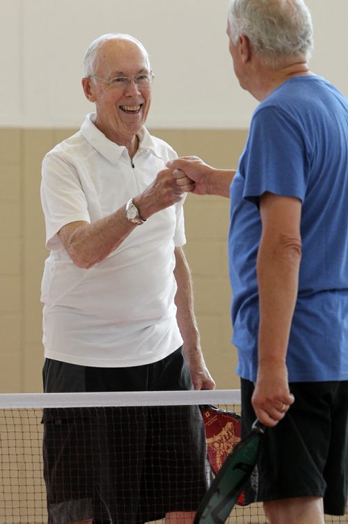 Larry Ladyman fist bumps his brother, Terry after beating him in a game of Pickleball, a sport that is a little bit badminton, a little bit tennis, at the Sturgeon Heights Community Centre Wednesday morning. 140219 - Wednesday, February 19, 2014 -  (MIKE DEAL / WINNIPEG FREE PRESS)