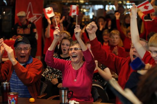 in pic (centre) Annette Lafreniere   husband Dennis (left)  , right Les Oliver  celebrates  with  St. Vital Curling fans when Jennifer Jones won Gold at the Sochi Olympics  with Yes, St. Vital CC is opening the doors at 6:30 am (game is at7:30 am) for a viewing party . The club is filling up with members and fans including Kerry Kohut  with her cow bell leading the cheers . We hope to have a large crowd of our members  out to watch the gold-medal game featuring Jennifer Jones At Sochi Olympic Gold medal Game FEB. 20 2014 / KEN GIGLIOTTI / WINNIPEG FREE PRESS