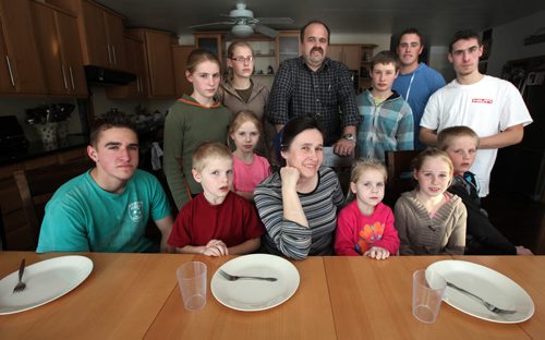 The DIK Family (or at least 13 of the 17) pose for an impropteau portrait Thursday. Back L-R row Anika (13), Lisa (8) in pink, Hannah (14), Jacob (Dad), Johannes (17), David (22), Daniel (19). Front seated L-R Sam (17) Nathan (7), Lina (mom) Nelly (5), Helen (10) and Jonathan (11).  See Bill Redecopp story AND Video re: 13 orphaned kids adopted by their Uncle and Aunt. February 20, 2014 - (Phil Hossack / Winnipeg Free Press)