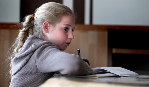 Ten yr old Helen pours over her homework at the kitchen room table before helping prepare supper. See Bill Redecopp story AND Video re: 13 orphaned kids adopted by their Uncle and Aunt. February 20, 2014 - (Phil Hossack / Winnipeg Free Press)