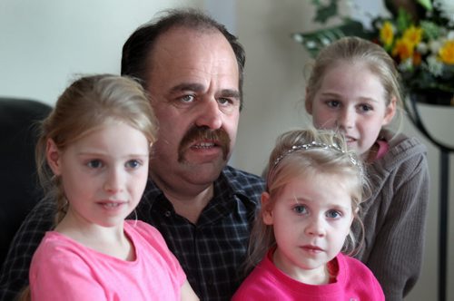 Jacob Dik sits with Lisa (8), Nelly (5), and Hanna (14). See Bill Redecopp story AND Video re: 13 orphaned kids adopted by their Uncle and Aunt. February 20, 2014 - (Phil Hossack / Winnipeg Free Press)