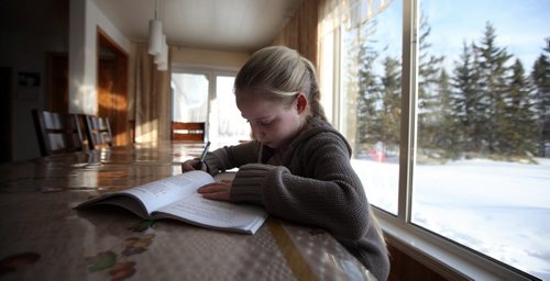 10 yr old Helen works at her homework at the Kitchen table after school. See Bill Redecopp story AND Video re: 13 orphaned kids adopted by their Uncle and Aunt. February 20, 2014 - (Phil Hossack / Winnipeg Free Press)