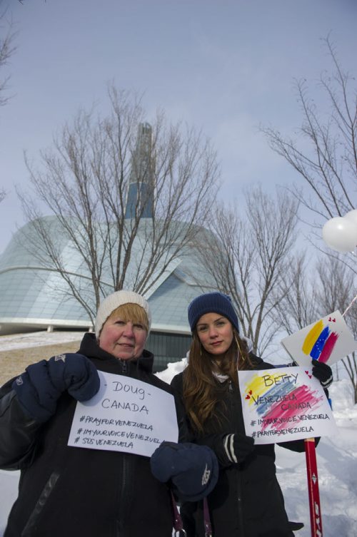 140222 Winnipeg - DAVID LIPNOWSKI / WINNIPEG FREE PRESS - February 22, 2014  Debbie Mihalyk (left) and Betty Paz at the rally for Venezuela. A group braved the cold Saturday afternoon to rally support for Venezuela in front of the Canadian Museum for Human Rights to raise awareness of alleged human rights violations in the country.