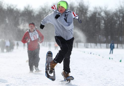 Gabriel Mayham leaves his opponents in the dust as he races down the snow packed 100m snowshoe course in the field at ST. John's Ravenscourt while competing in the 34th Annual Kinsmen Winnipeg WInter Games Saturday Afternoon.  Standup photo Feb 22,, 2014 Ruth Bonneville / Winnipeg Free Press